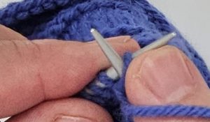 Carson Demers, showing the English style of knitting setup